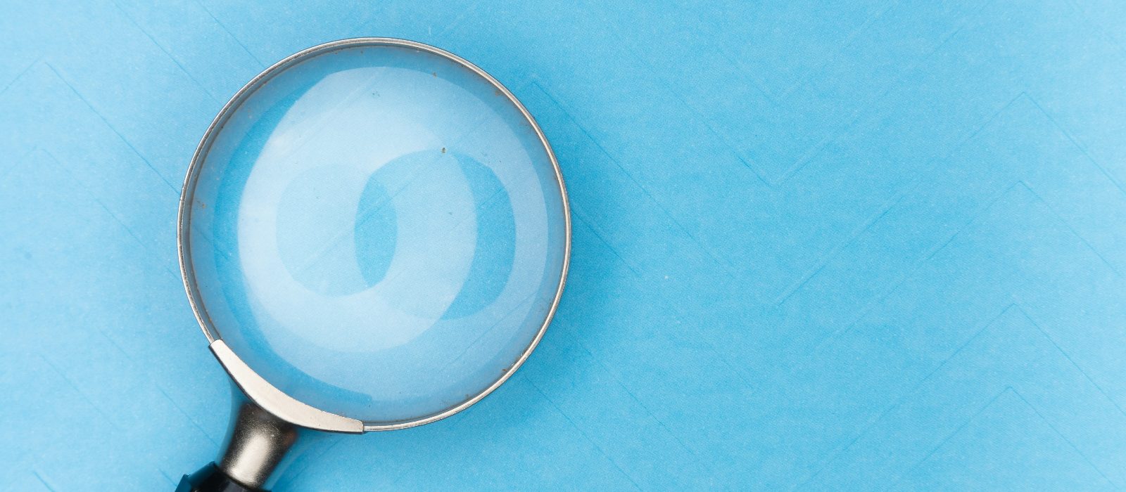 A magnifying glass on a blue background